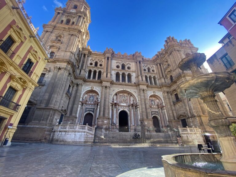 a large building with a fountain in front in Malaga